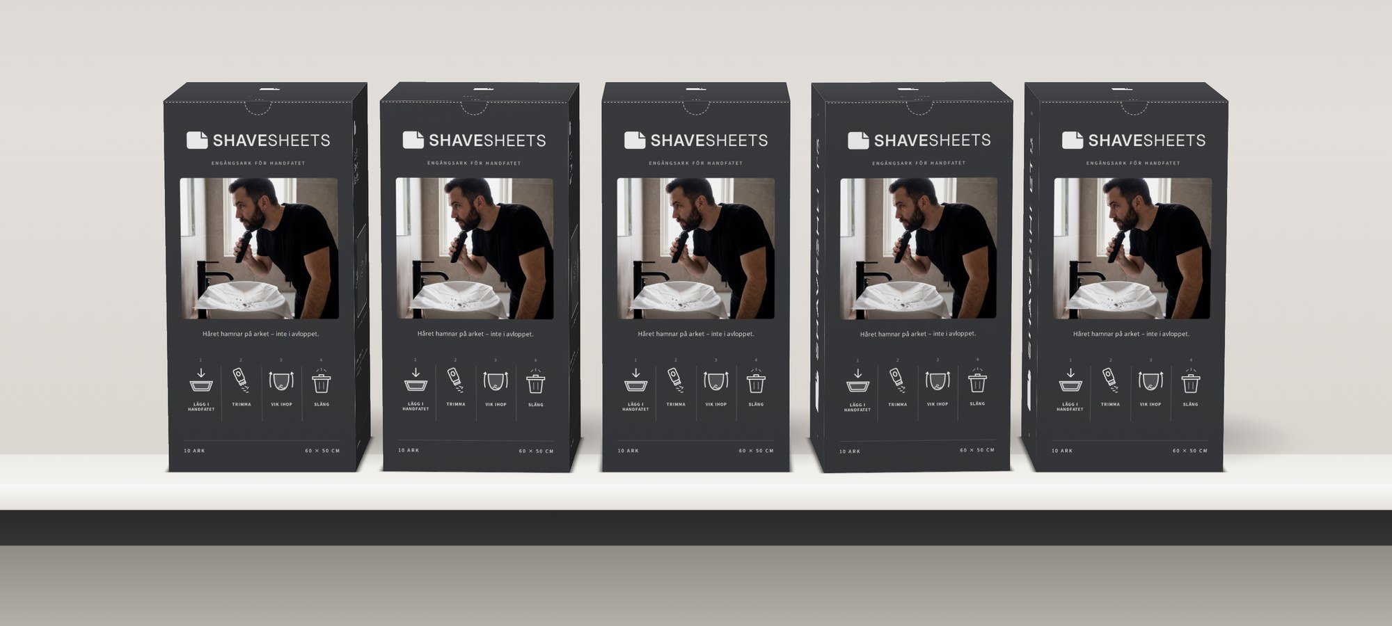 Fem ShaveSheets-boxar i rad på en hylla.